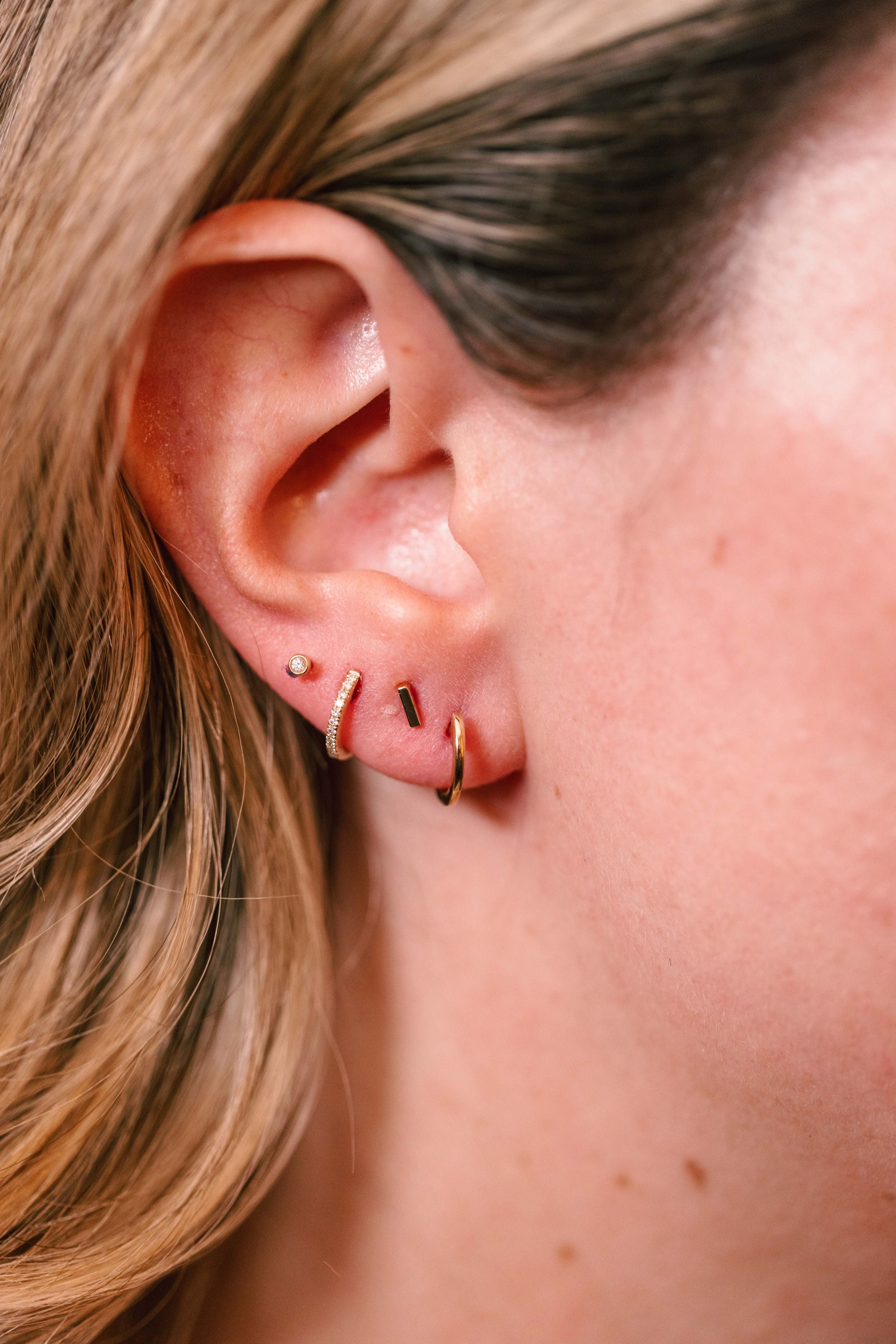 Gold Huggie Earrings 14k Yellow Gold - 11.5mm modeled